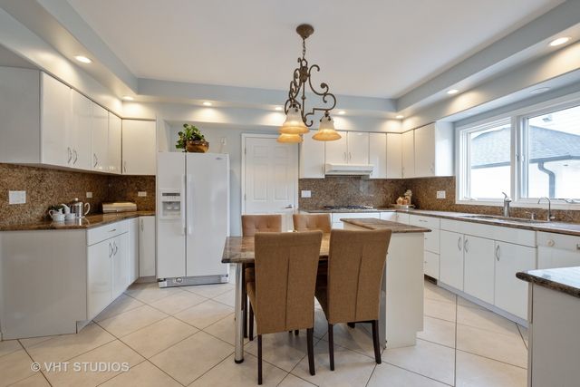 a kitchen with cabinets a sink and appliances