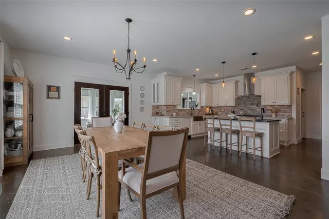 a view of a dining room with furniture wooden floor and a chandelier