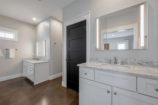 a bathroom with a double vanity sink and mirror