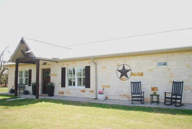 a view of a house with swimming pool and sitting area