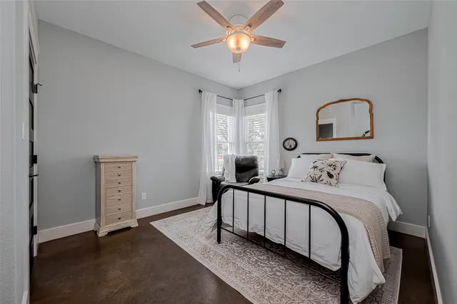 a bedroom with a bed and a ceiling fan