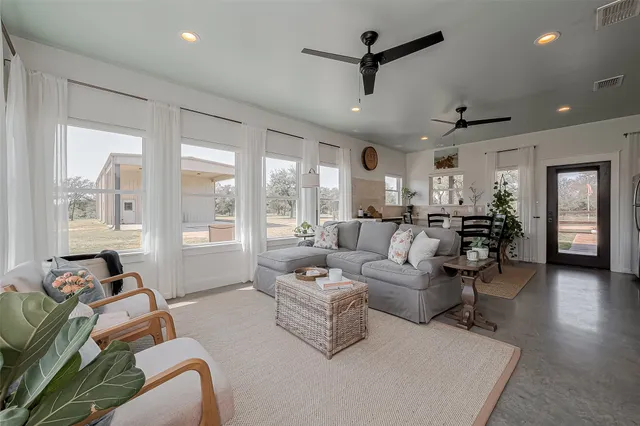 a living room with furniture and a large window