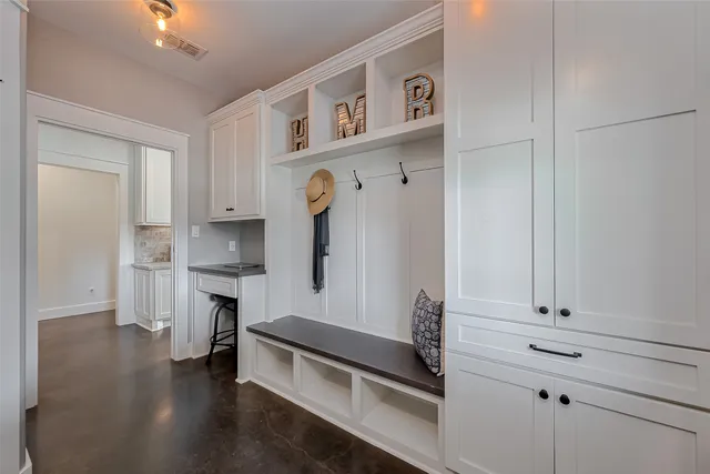 a kitchen with white cabinets and appliances