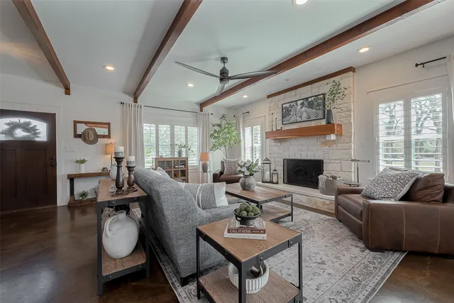 a living room with furniture a fireplace and a flat screen tv