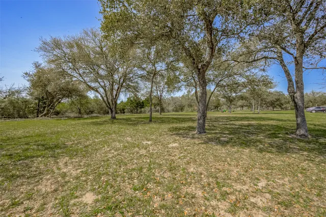 a view of backyard with wooden fence