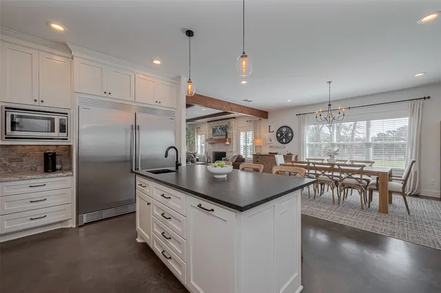 a kitchen with sink cabinets and refrigerator