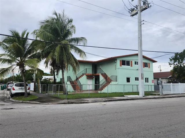 a view of street along with house and trees
