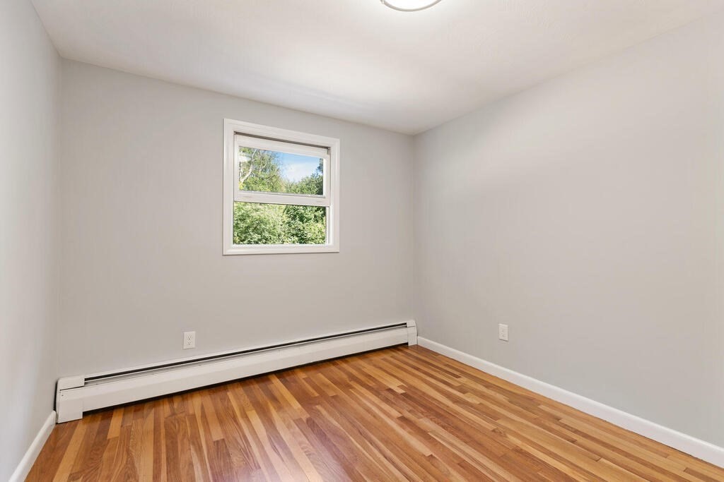 8 Smith Road Randolph, MA 02368 - Photo 17 of 31 a view of an empty room with wooden floor and a window