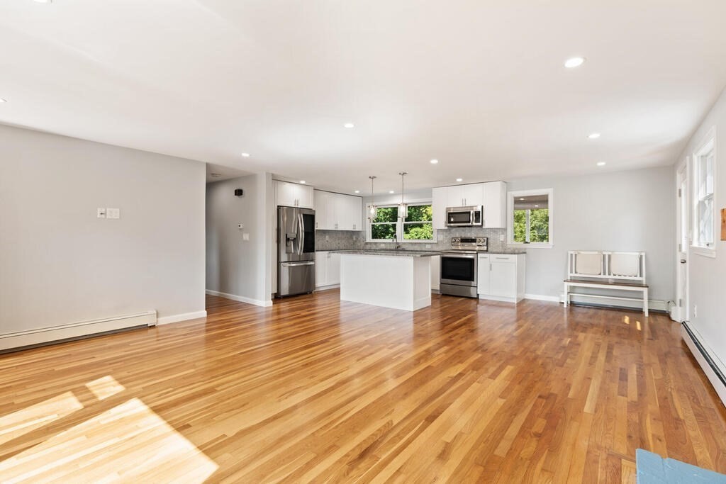 8 Smith Road Randolph, MA 02368 - Photo 7 of 31 a kitchen with stainless steel appliances a refrigerator and a stove top oven