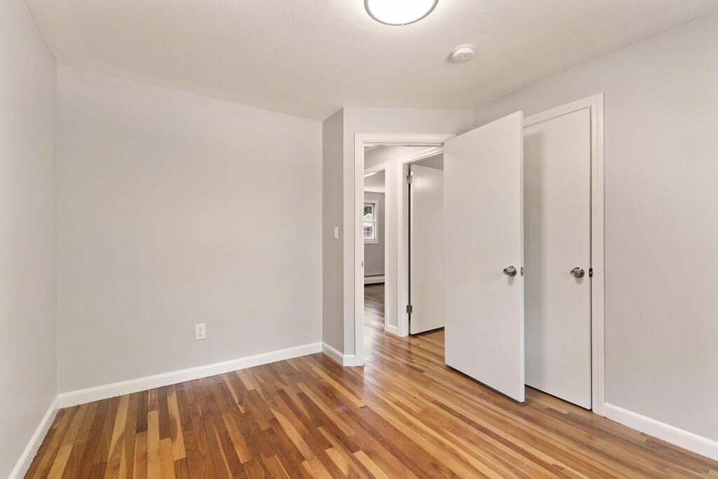 8 Smith Road Randolph, MA 02368 - Photo 10 of 31 a view of an empty room with wooden floor