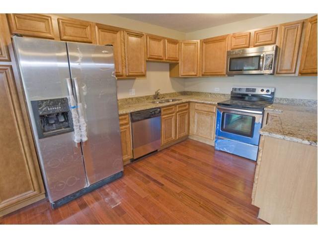 Remodeled kitchen with granite counter tops and new stainless steel Whirlpool appliances