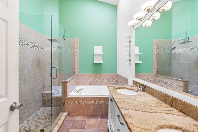 a bathroom with a granite countertop sink a mirror and shower