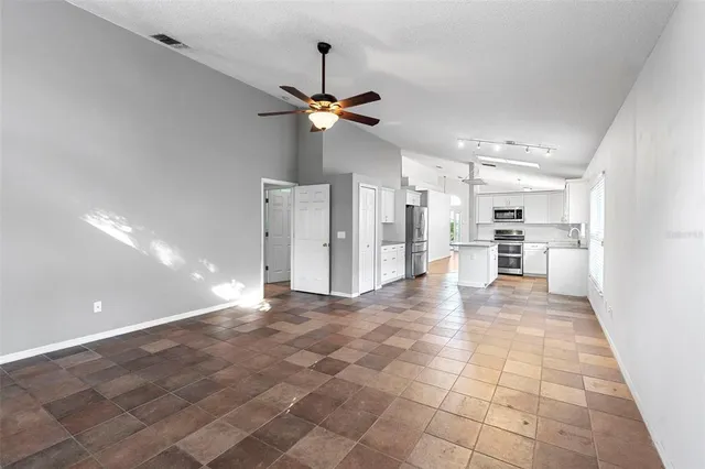 a view of a kitchen with a sink and a refrigerator