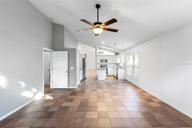 a view of a livingroom with a ceiling fan and window