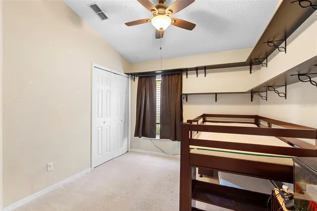 a view of a hallway with a ceiling fan