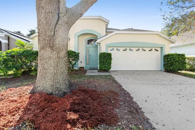 a view of a house with a yard and garage