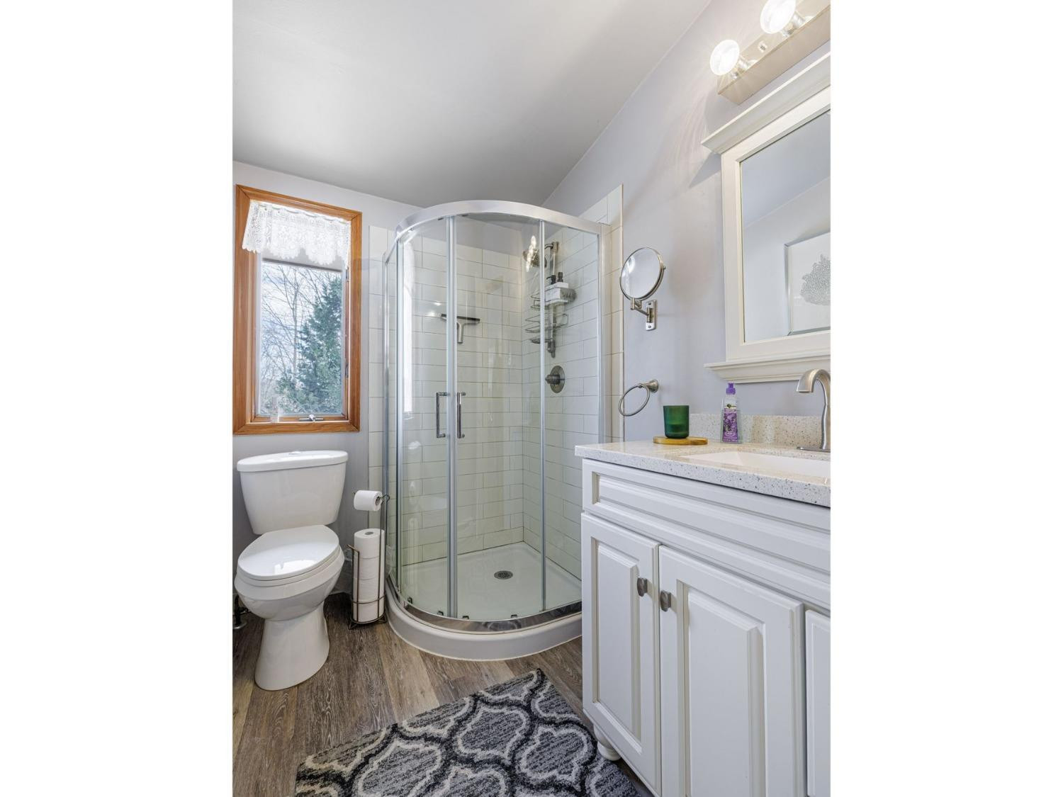 89 Siam Road Windham, NY 12496 - Photo 24 of 31 a bathroom with a granite countertop toilet a sink a mirror and a shower