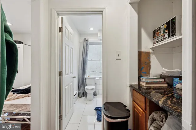 a bathroom with a toilet and a mirror