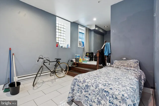 a bedroom with furniture and a window