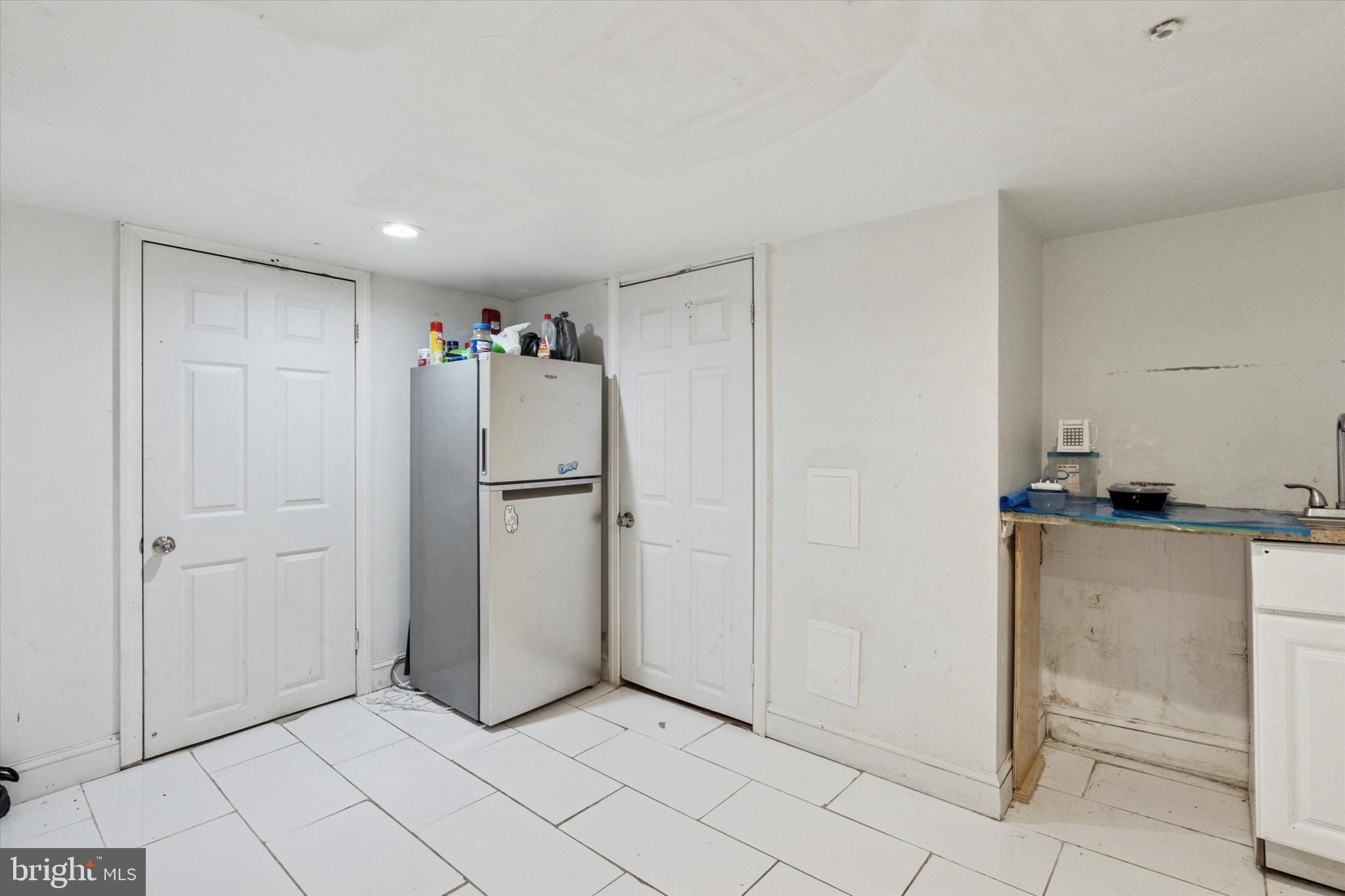517 North 35th Street Philadelphia, PA 19104 - Photo 10 of 24 a view of a kitchen with white cabinets and refrigerator