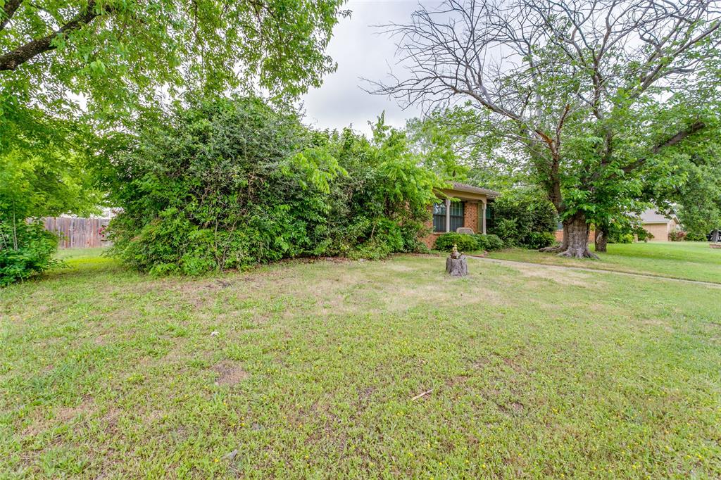 a man is standing in a yard with swimming pool