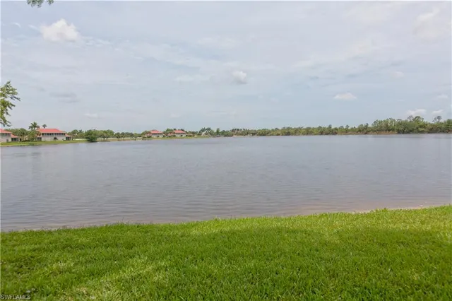 a view of a lake with houses in the back
