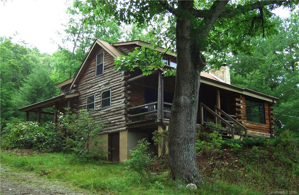 833 Hidden Valley Road Clyde, NC 28721 - Photo 1 of 14 a backyard of a house with lots of green space