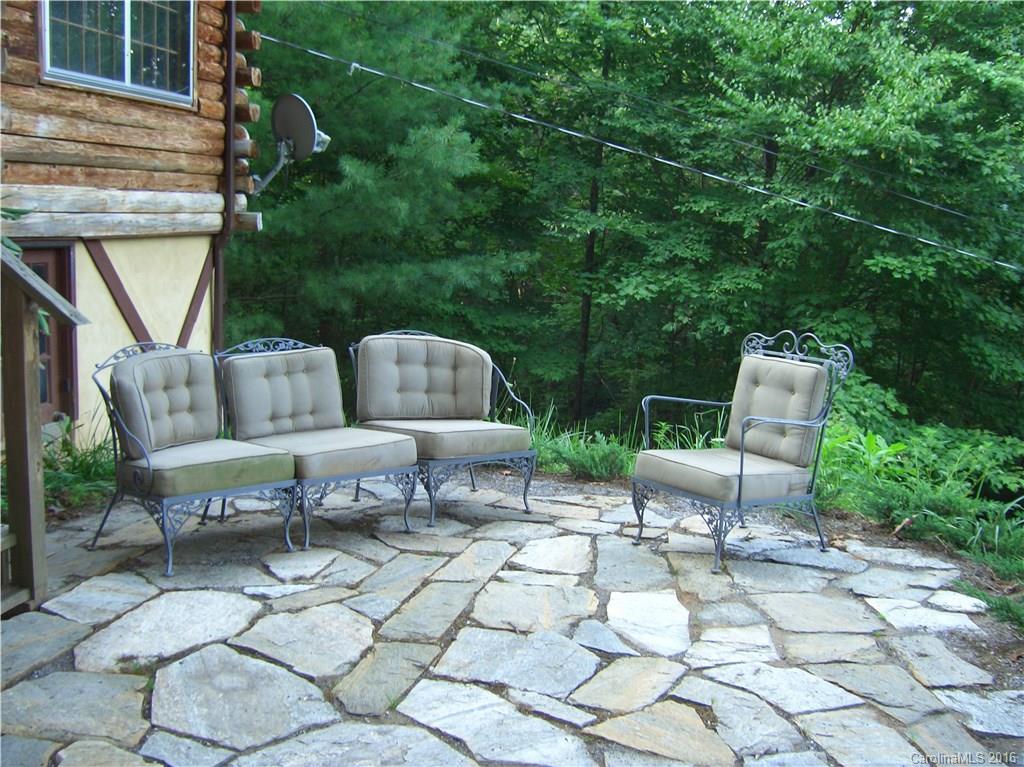 833 Hidden Valley Road Clyde, NC 28721 - Photo 9 of 14 a view of backyard with outdoor seating and plants