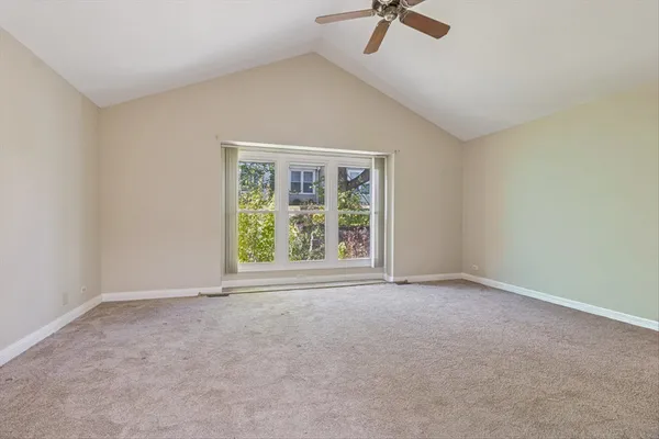 an empty room with closet and a window
