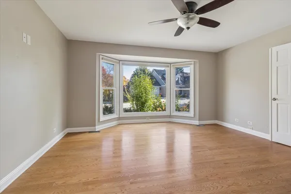 a kitchen with granite countertop white cabinets stainless steel appliances and a window