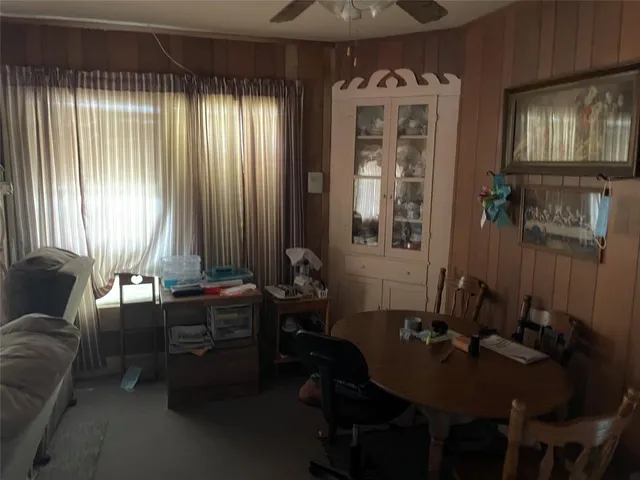 a room with furniture and large windows