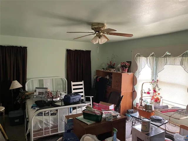 a work room with furniture and a flat screen tv