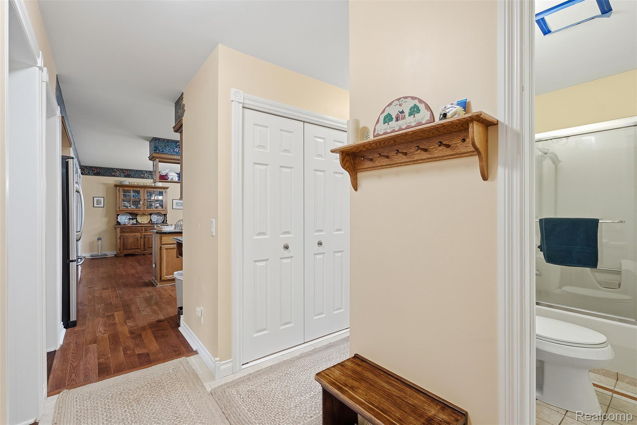 13182 Gilbert Road Memphis, MI 48041 - Photo 13 of 48 Hallway featuring white bi-fold closet doors, cream-colored walls, and textured carpet flooring