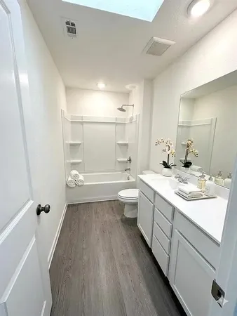 a room with a sink a vanity and mirror