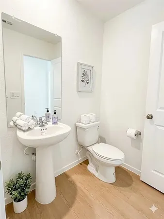 a bathroom with a double vanity sink a toilet and a tub