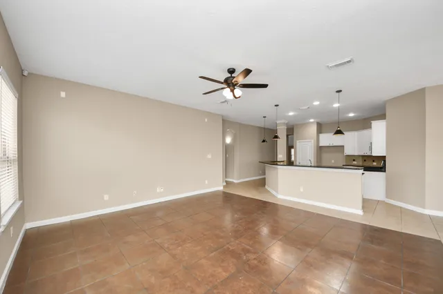 a view of an empty room with a kitchen