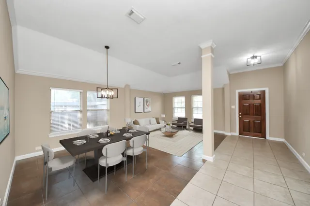 a living room with fireplace furniture and a large window