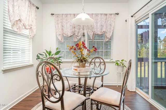 a view of a dining room with furniture wooden floor and chandelier