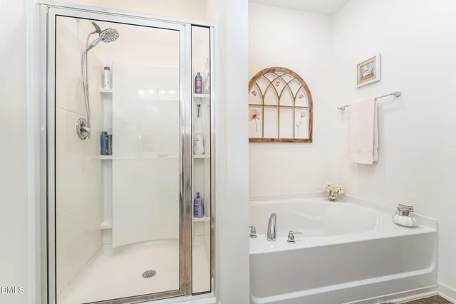 a bathroom with a glass shower door and a sink
