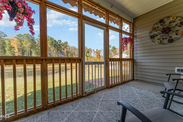 a view of a porch with a table and chairs