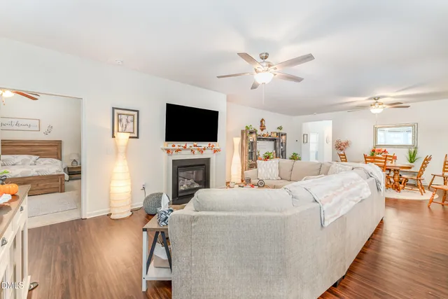 a living room with furniture a fireplace and a flat screen tv