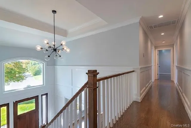 a view of a hallway with a chandelier