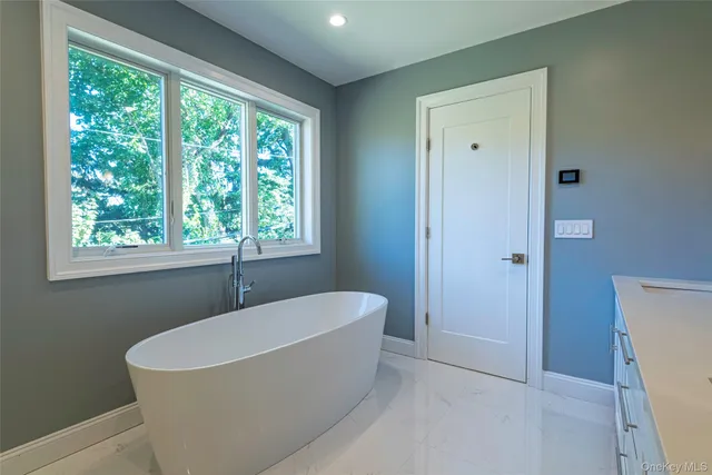 a bathroom with a bathtub and window