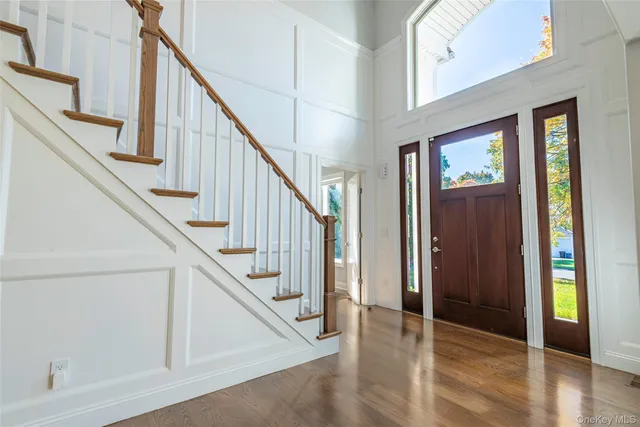 a view of an entryway with wooden floor