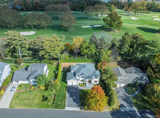 an aerial view of residential houses with outdoor space and street view