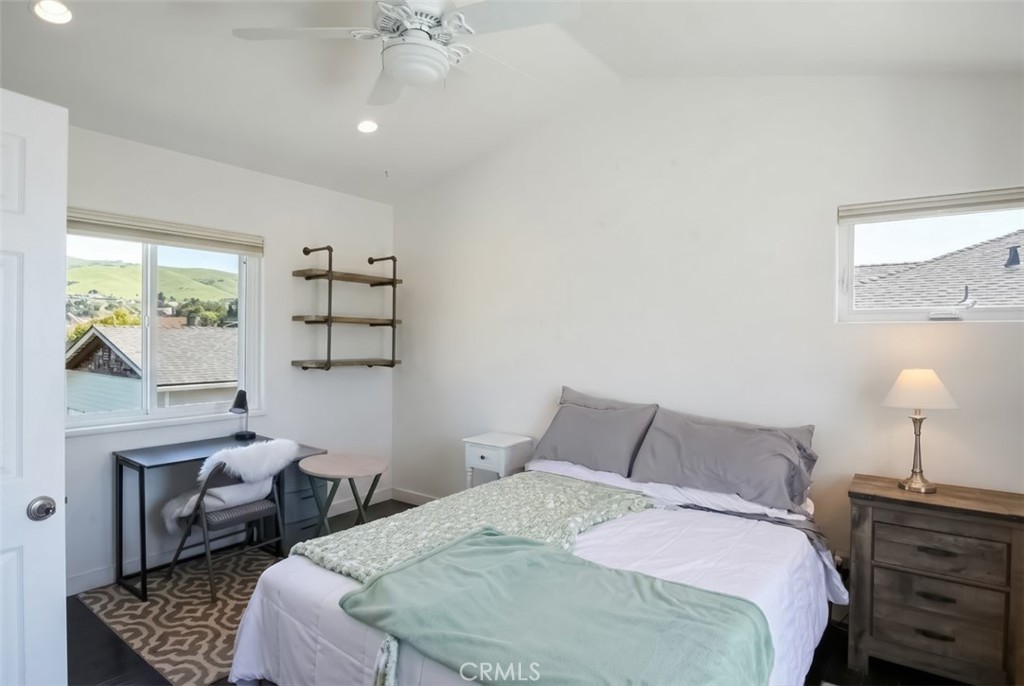 350 Java Street Morro Bay, CA 93442 - Photo 18 of 26 a bedroom with a bed and a chandelier