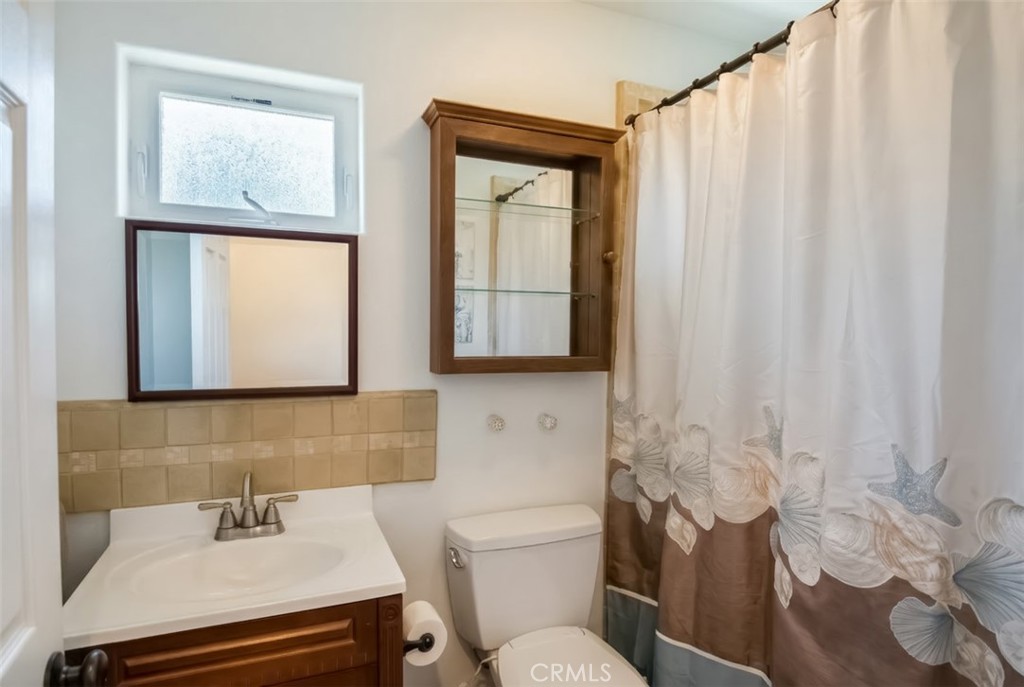 350 Java Street Morro Bay, CA 93442 - Photo 25 of 26 a bathroom with a sink toilet and mirror