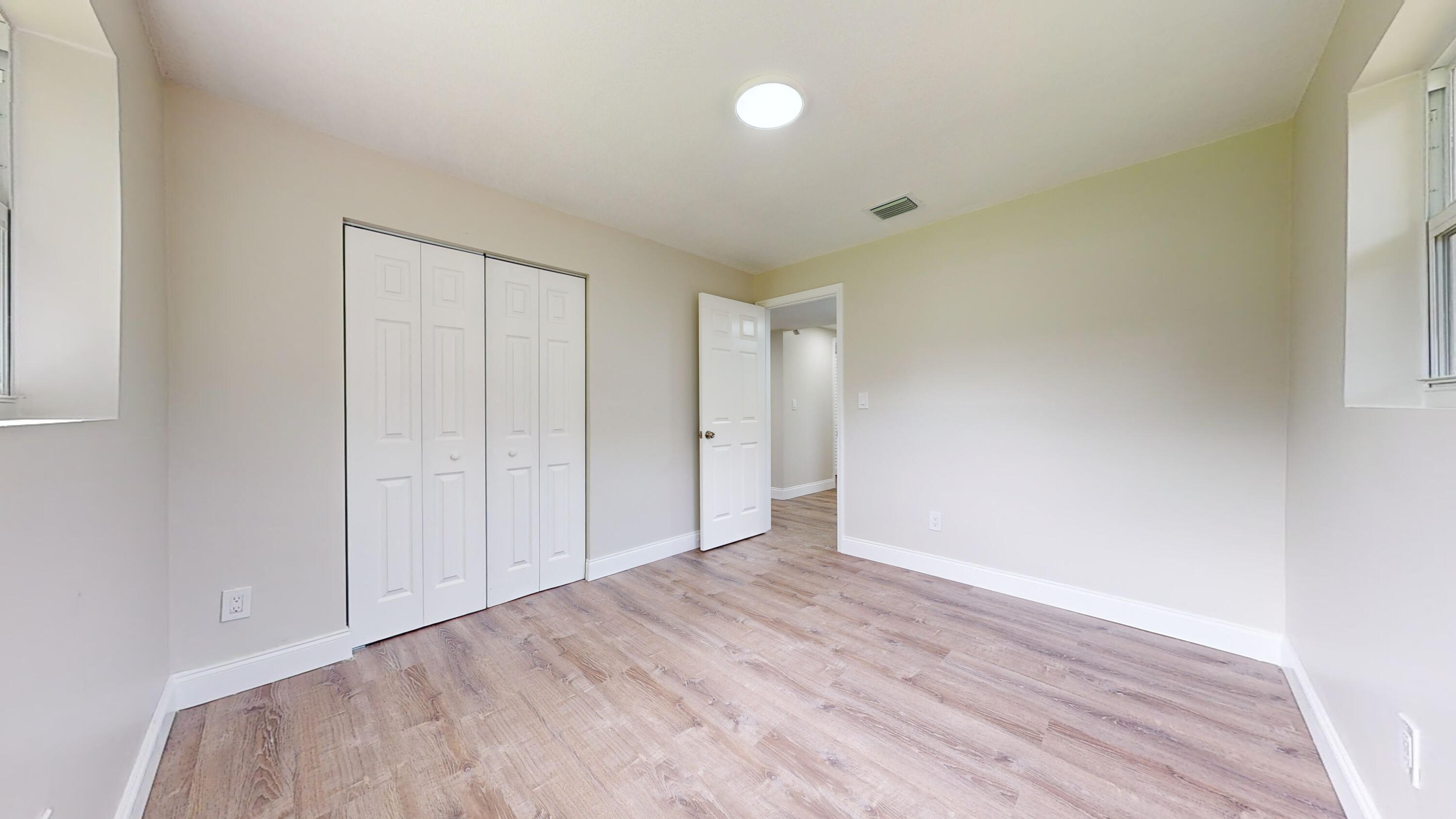 6674 4th Street Jupiter, FL 33458 - Photo 11 of 21 a view of an empty room and wooden floor