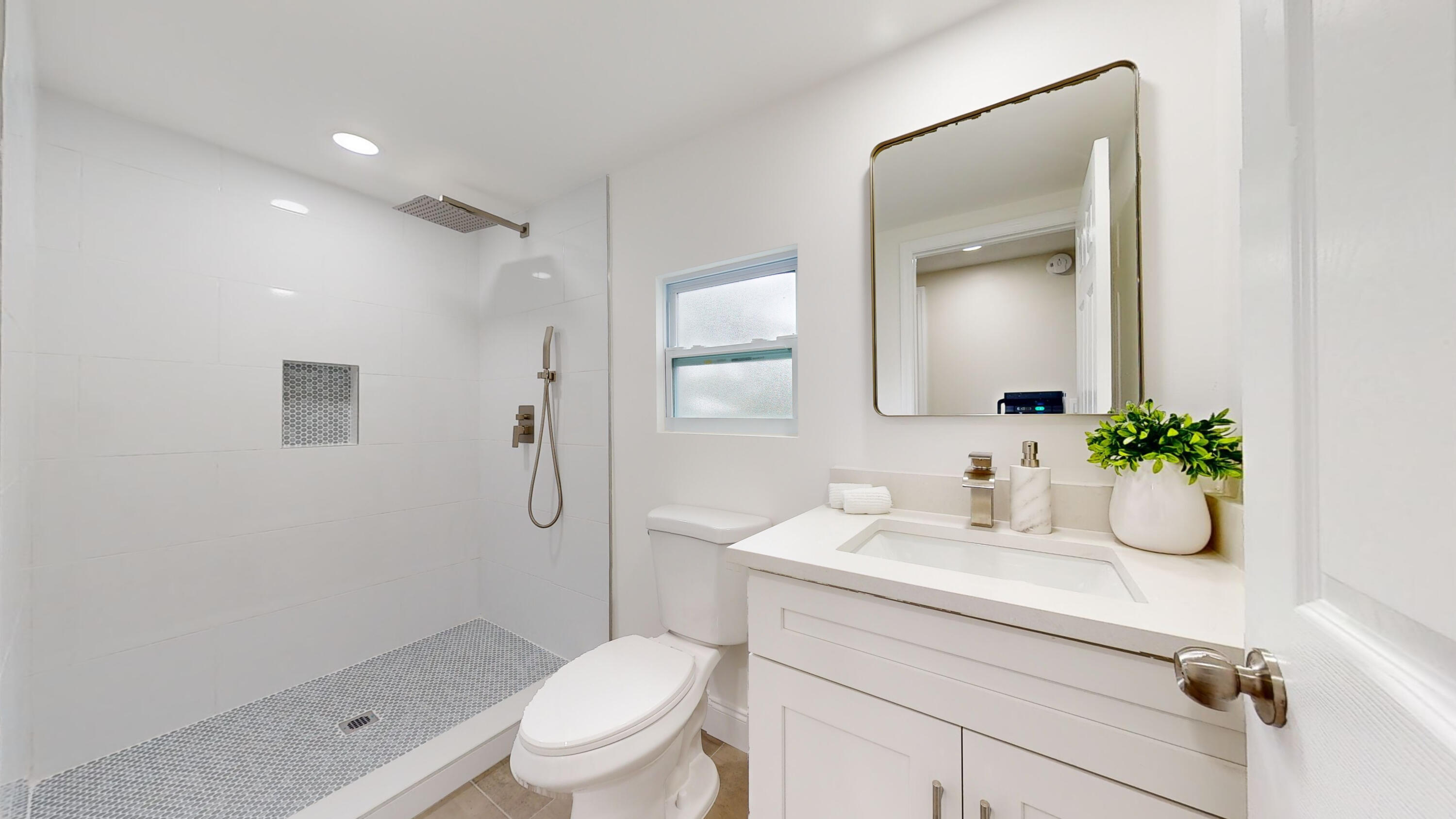 6674 4th Street Jupiter, FL 33458 - Photo 12 of 21 a bathroom with a sink a toilet and shower