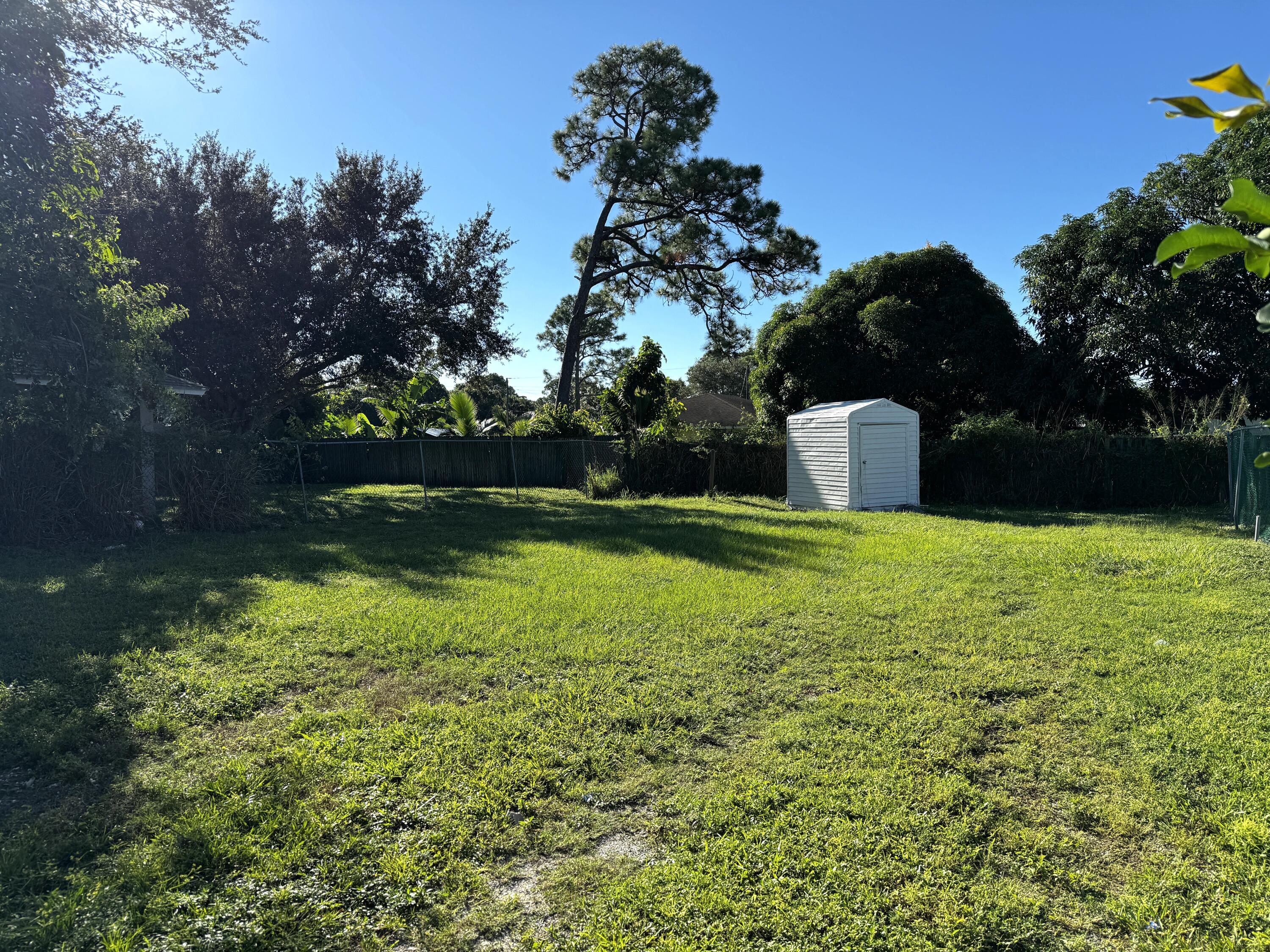 6674 4th Street Jupiter, FL 33458 - Photo 20 of 21 a view of yard with swimming pool and green space